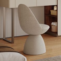 an egg chair sits in the corner of a bedroom