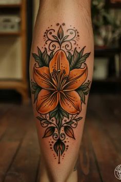 an orange flower tattoo on the leg