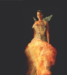 a woman in a dress with fire on it