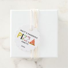 a white box with some string attached to it and a tag that says matt's pandemic party