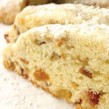 two pieces of cake sitting next to each other on a white tablecloth covered with powdered sugar