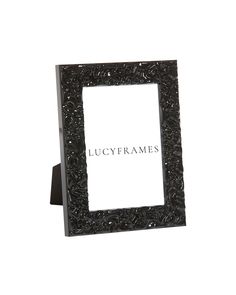 a black frame sitting on top of a white wall next to a sign that says ugly frames