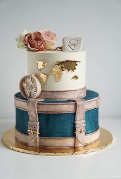 a three tiered cake with gold and blue decorations