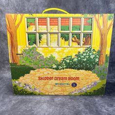 a box with an image of a yellow house and trees in the background that says, skupper dream room