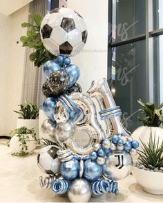 a large number made out of balloons in the shape of a soccer ball and numbers