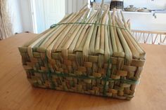 a bamboo basket sitting on top of a wooden table