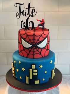 a spiderman themed birthday cake with the words fate is 6 on top and an image of a person jumping over it