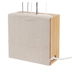 a wooden box with four forks sticking out of it's sides and two cords attached to the side