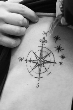 a person with a compass tattoo on their back