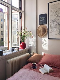 a bedroom with a window, radiator, and bed in front of it