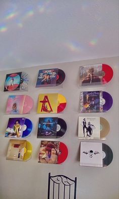 there are many different colored records on the wall