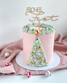 a pink cake decorated with a christmas tree