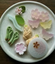 a plate with different types of food on it, including flowers and leaves in the center