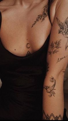 a woman with tattoos on her arm and chest