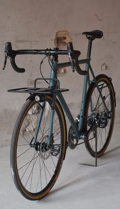 a bicycle parked in front of a wall