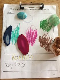 a piece of paper that has different colored crayons on it and some rocks