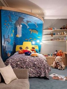 a child's bedroom decorated in blue, yellow and orange with dolphins on the wall