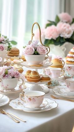 a table topped with lots of plates and cups filled with pastries on top of each other