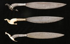 three knives are shown on a black background