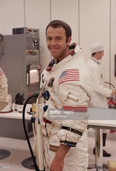 an astronaut standing in the space station with his hands on his hips and looking at the camera