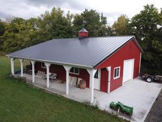 a red and white barn with a metal roof