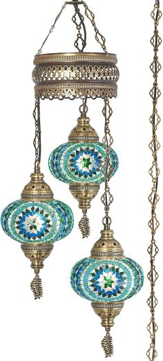 two decorative hanging lights with blue and green designs on them, one is made out of metal