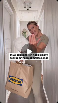 a woman holding a brown bag in her right hand and the text ikea organization hack's in my bedroom that just makes sense