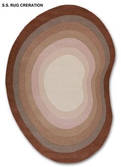 an oval rug with different colors and shapes on the floor, including brown, pink, beige