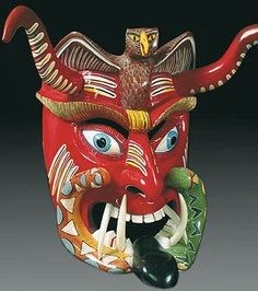 a red mask with an eagle on it's head and two hands in the mouth