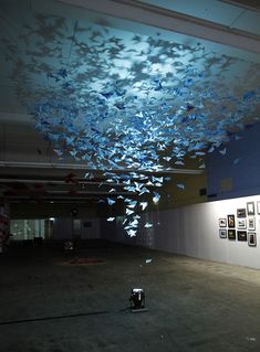 a room filled with lots of pictures on the wall and ceiling covered in blue lights