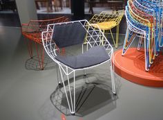 four chairs with different colors and shapes on display