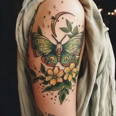 a woman's arm with a butterfly and flowers tattoo on the left side of her body