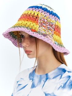 a woman wearing a multicolored crocheted hat