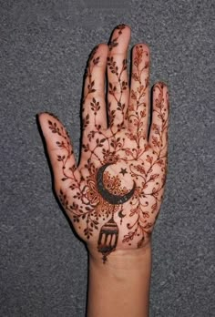 a person's hand with henna tattoos on it