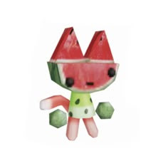 a watermelon shaped paper toy sitting on top of a white surface