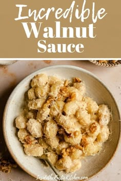 a bowl filled with some kind of food on top of a white tablecloth and the words incredible walnut sauce above it