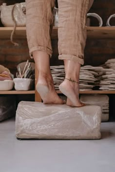 a person standing on top of a mattress in a room