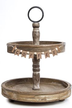 two tiered wooden tray with an iron ring on the top and bottom, sitting in front of a white background