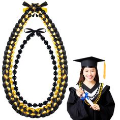 a woman wearing a graduation cap and gown holding a tasseled beaded necklace