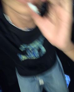 a blurry photo of a person holding a cell phone