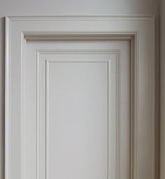 an empty white door in the corner of a room