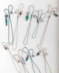 several necklaces are arranged on a white surface