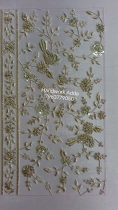 the back side of a card with gold flowers and leaves on it