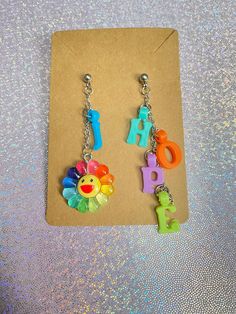 If your bias is J-Hope, then these Jhope earrings are the perfect way to show your love for J-Hope! Lightweight and colorful, these are a OOAK earrings that won't be found anywhere else but here❤️. Check out our kpop merch for more kpop themed items! *Stainless steel material only *Letter color is chosen randomly  *The left earring is 1.5 inches long and the right 2 inches long If you have any questions, please don't hesitate to ask! We are friendly:) Visit our official website: www.yeetincolorboutique.com and follow us on Instagram: @yeetincolorboutique Jhope Earrings, Kpop Jewelry, Kawaii Bracelet, Kpop Earrings, Kawaii Necklace, Kpop Merch, J Hope, Flower Charm, Star Necklace