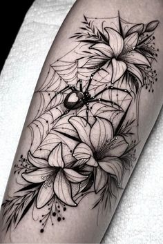 a black and white flower tattoo on the leg