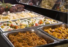 an assortment of food in trays on display at a buffet stock photo