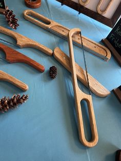 various woodworking tools and pine cones on a blue tableclothed surface with writing