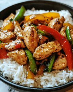 chicken and peppers with rice in a black bowl