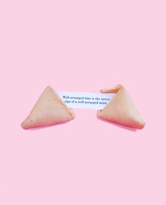 two triangular shaped objects on a pink background