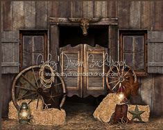 an old wooden building with hay bales and other items